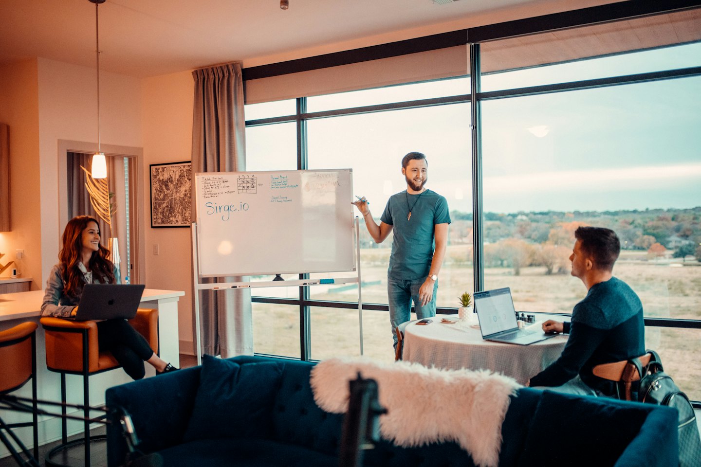 Professionals collaborate in a bright office meeting space.
